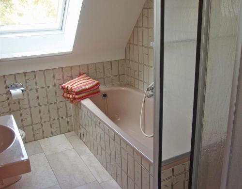 a bathroom with a bath tub and a sink at Fewo Glücksburg in Ulsnis