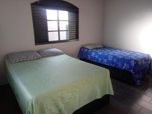 ピレノポリスにあるCasa 57 Temporadaの窓のある部屋にツインベッドが2台