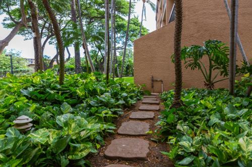 a garden with rocks and plants in front of a building at Maui Vista Vacation Condo in Kihei