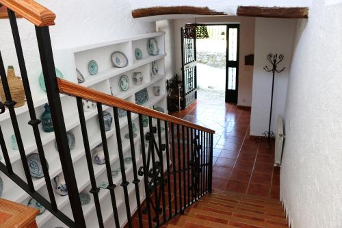 a staircase with blue and white plates on the wall at Cauchil Chico in Alcalá la Real