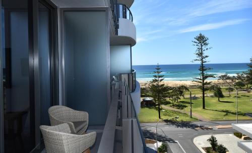 a balcony with chairs and a view of the ocean at X Kirra Apartments in Gold Coast