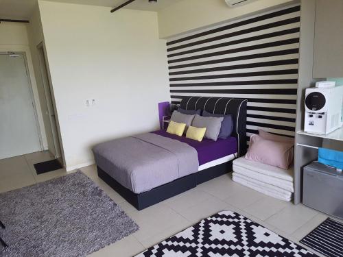 a bedroom with a bed with pillows on it at Mufasa Suites at Tamarind Suites with Wifi Netflix Coway Level 8 in Cyberjaya