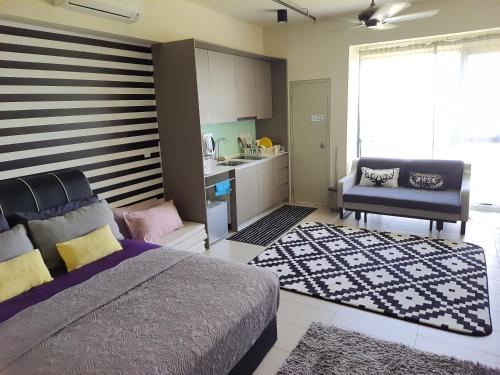 a bedroom with a large bed and a kitchen at Mufasa Suites at Tamarind Suites with Wifi Netflix Coway Level 8 in Cyberjaya