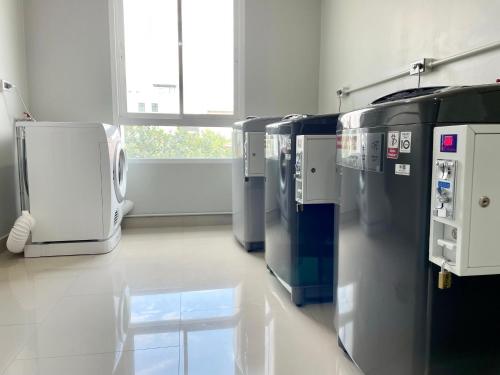 a laboratory with a row of refrigerators in a room at Sabai Residence @Bangyai in Nonthaburi