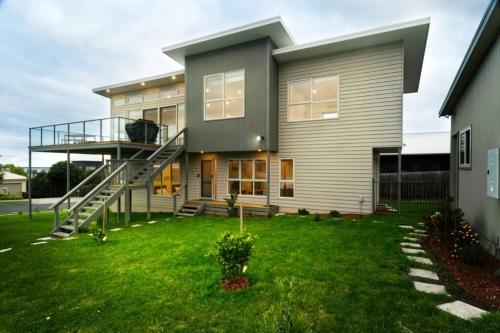 a house with a staircase in the yard at Ocean Loft - Oceanview ~Pet Friendly ~ Free Wifi in Apollo Bay
