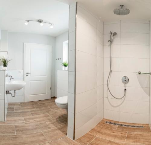 a bathroom with a shower and a toilet at Ferienhaus Seeblick - 78913 in Gammendorf