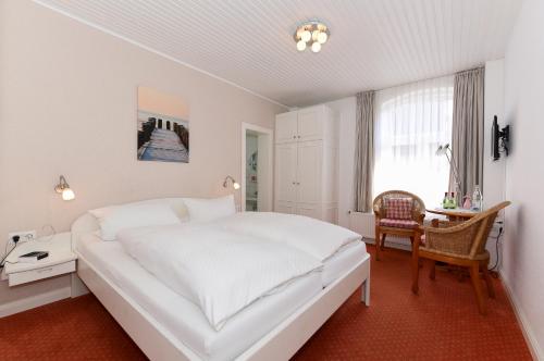 En eller flere senge i et værelse på Pension Hilligenlei Zi 08 DZ