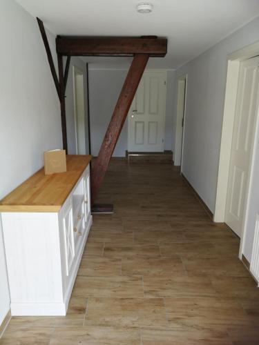 a hallway with a wooden beam in a house at Pension Schlossblick Thallwitz in Thallwitz