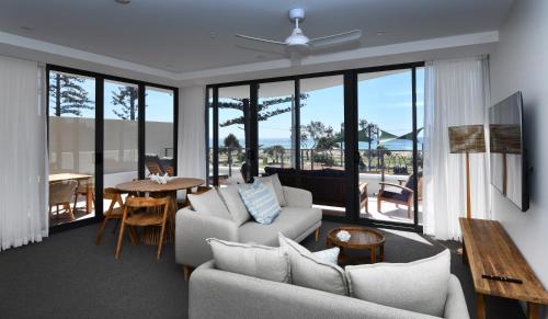 a living room with a couch and a table at X Kirra Apartments in Gold Coast