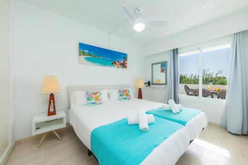 a bedroom with two beds and a window at Alcudia Sea Apartment in Alcudia