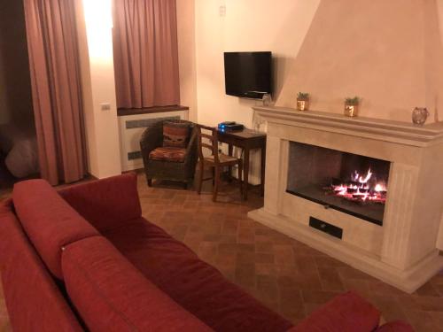 a living room with a couch and a fireplace at La Dimora nel Corso in Montepulciano