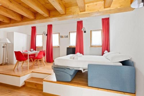 a bedroom with a large bed and a table at Gressoney Saint-Jean apartments by Halldis in Gressoney-Saint-Jean