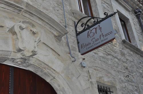 a sign hanging on the side of a building at RELAIS SAN MARCO LUXURY GUEST HOUSE in Volturino