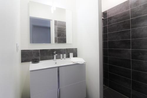 une salle de bain avec un lavabo blanc et un miroir dans l'établissement You & Me avec Balcon et parking privé, à Sarlat-la-Canéda