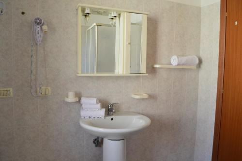 a bathroom with a sink and a mirror at Le Zagare Case Vacanza in Cropani