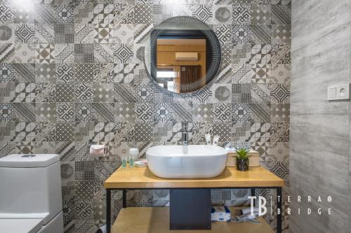 a bathroom with a sink and a mirror at Terra Bridge in Tbilisi City