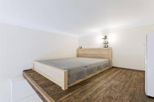 a bedroom with a bed and a wooden floor at City Center Loft Apartment in Tallinn