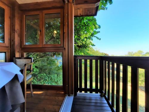 a screened in porch with a view of the woods at Casa sull'Albero Aromantica in San Salvatore Monferrato
