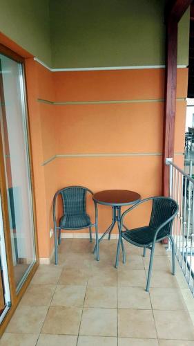two chairs and a table on a balcony at Rezydencja 5 Dębów in Międzyzdroje