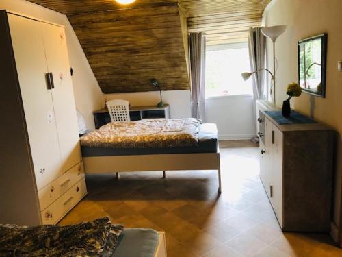 a bedroom with a bed and a sink and a tub at TS Monteurzimmer in Lübeck