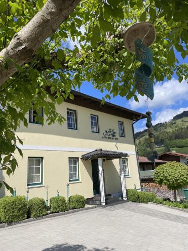 a building in front of a building with a tree at Appartment Martin in Westendorf