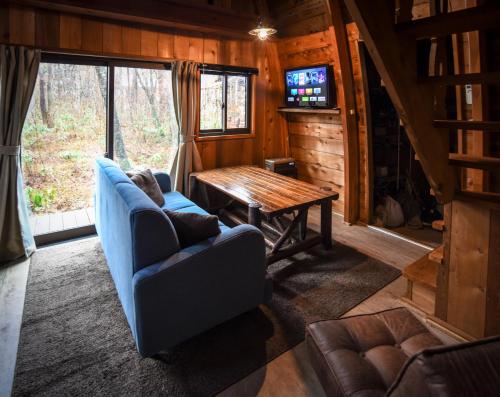 a living room with a couch and a table at The Hut in Hakuba