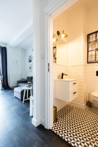 a bathroom with a sink and a toilet at One Night Lofty Fabryczna in Zielona Góra