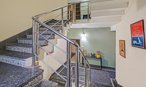 a spiral staircase in a home with a stair case at Treebo The Bollywood in Bhubaneshwar