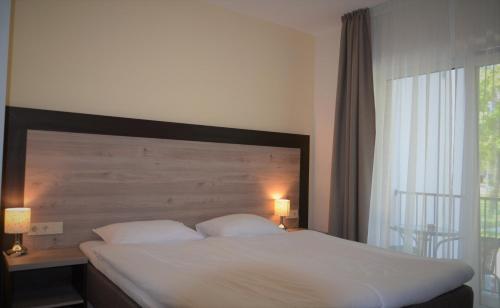 Una cama o camas en una habitación de Labas Rytas Vila