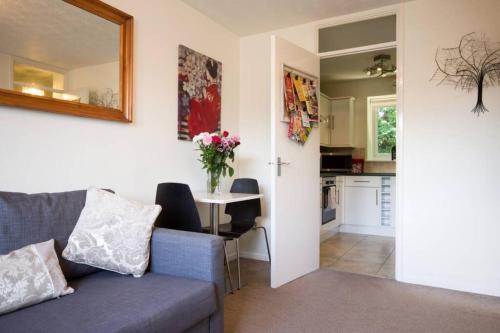a living room with a couch and a table at 1 bedroom, self check-in, central and quiet apartment up to 3 in Newbury in Newbury
