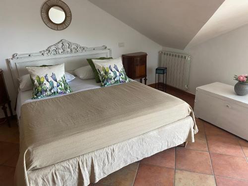 a bedroom with a bed and a mirror on the wall at Tyrrhenian Sea Apartment in Torre Faro