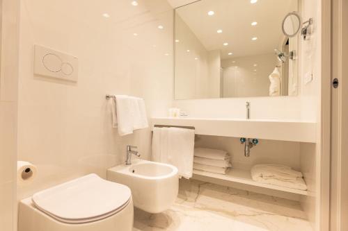 a bathroom with a sink and a toilet and a mirror at Hotel Morfeo in Milan