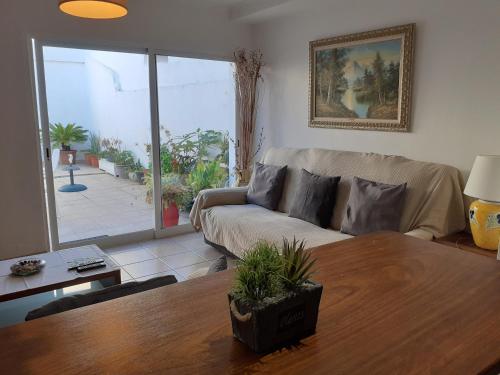 a living room with a couch and a table at Casa Luz in Vila Nova de Milfontes