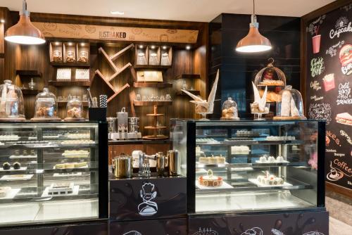 a bakery display case with cakes and other desserts at Radisson Bhopal in Bhopal