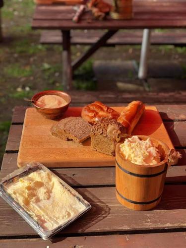 a table with a cutting board with bread and a container of butter at Mongolian Yurt Camp in Český Šternberk