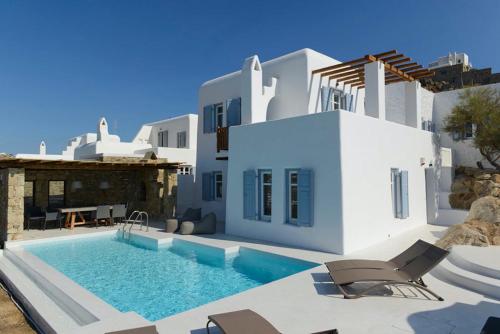 a villa with a swimming pool and a house at Villa Pearl near Ornos by Diles Villas in Agios Ioannis Mykonos