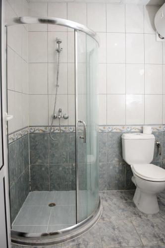 a bathroom with a shower and a toilet at Gardenia Vacation Settlement in Sozopol