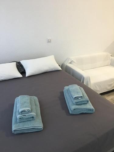 two beds with towels on top of a table at Estudio Estilo Nórdico Madrid (Malasaña Gran Vía) in Madrid