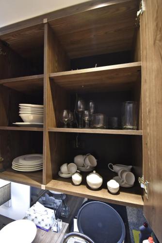 a cabinet filled with plates and bowls and dishes at Avenue ApartHotel in Yerevan