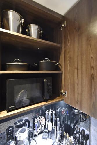 a kitchen with a stove with pots and pans at Avenue ApartHotel in Yerevan