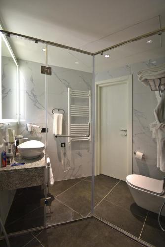 a bathroom with a shower and a sink and a toilet at Avenue ApartHotel in Yerevan