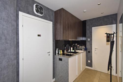 a kitchen with a white door and a counter at Avenue ApartHotel in Yerevan