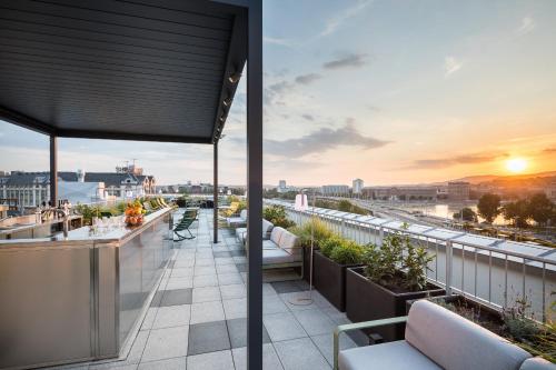 a rooftop patio with a view of a city at B&B Hotel Budapest City in Budapest