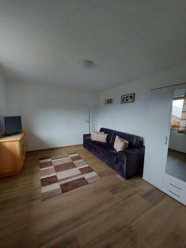 a living room with a couch and a table at Haus Bergglück in Kaunerberg