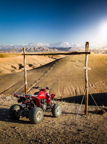 a red atv parked in the middle of a desert at Camp Cameleon in Marrakech