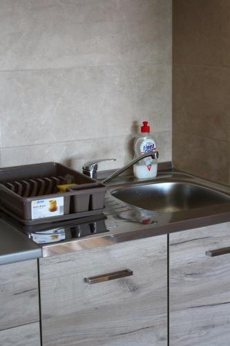 a kitchen counter with a sink and a sink at Exceptional Accommodation in Čačak