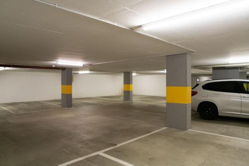 a parking garage with a white van parked in it at Chesa Seraina Abitaziun Seraina 4 - Sand - Madulain in Madulain