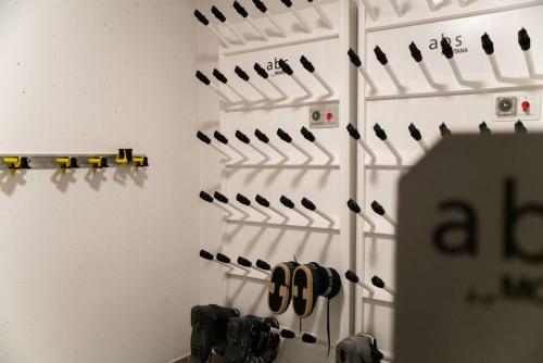 a wall with a bunch of pairs of shoes at Chesa Seraina Abitaziun Seraina 9 - Mahogany - Madulain in Madulain