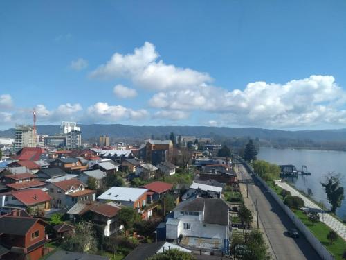 a view of a city with a river and buildings at Vista al río Calle - Calle in Valdivia