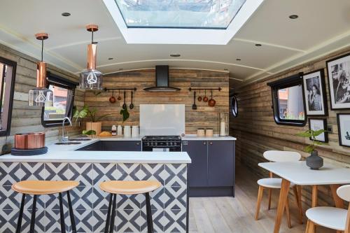 an rv kitchen with a counter and stools at The Boathouse in London